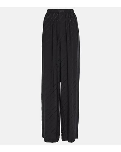 Balenciaga Pantalon ample a taille haute en soie a logo - Noir