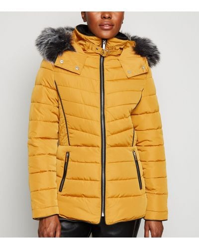 mustard puffer coat with fur hood
