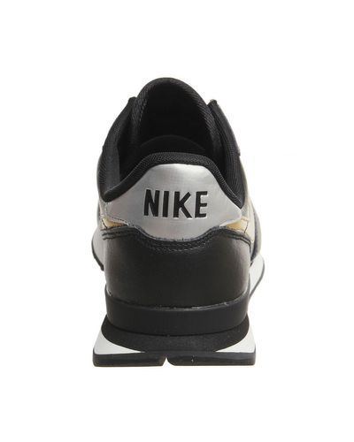 nike black and gold internationalist trainers