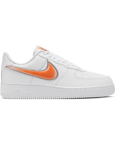white nike shoes with orange swoosh