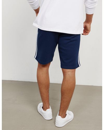white adidas with navy blue stripes