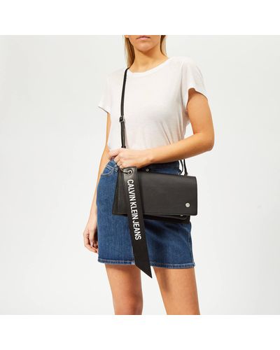 Calvin Klein Logo Banner Cross Body Flap Bag in Black - Lyst