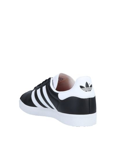 all black low top adidas