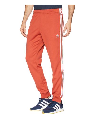 black orange adidas pants
