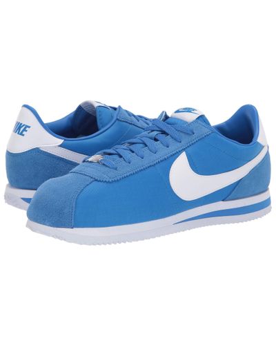 white and blue cortez shoes
