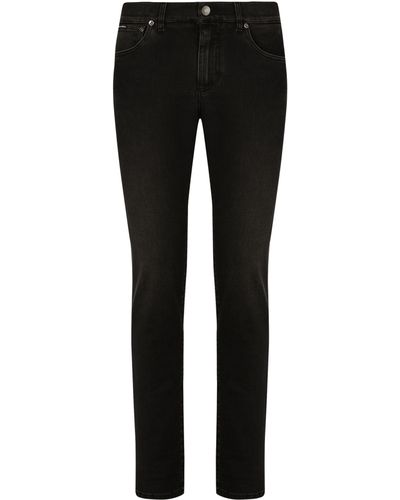Dolce & Gabbana Stretch-Jeans aus grauem Washed-Denim in Slim Fit - Schwarz