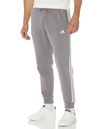 adidas Essentials Fleece Tapered Cuffed 3-stripes Pants in Gray for Men |  Lyst