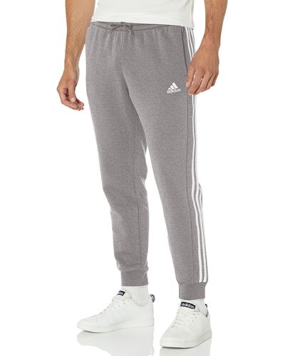 grey adidas sweatpants with white stripes