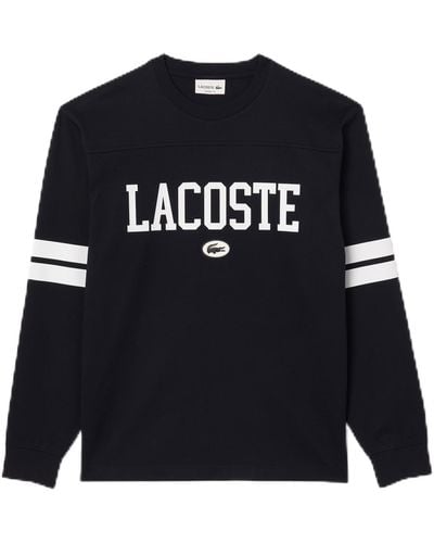 Lacoste Long Classic Fit Tee Shirt W/large Wording On Front And Stripes To Sleeves - Black