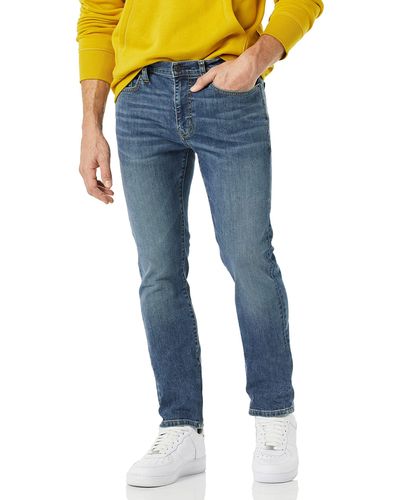 Amazon Essentials Jeans Elasticizzati a Vita Alta vestibilità Attillata Uomo - Blu