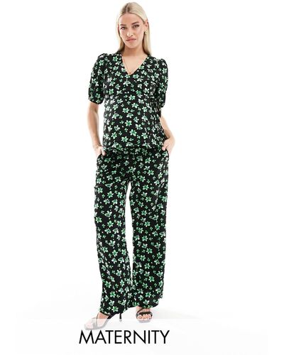 Mama.licious Mamalicious maternity - pantaloni comodi con fascia sotto il pancione e stampa di fiori di palma - Verde
