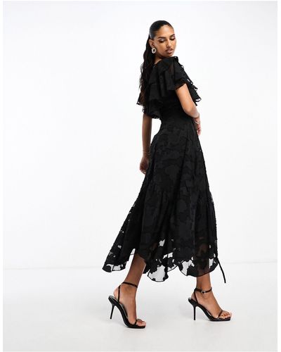 ASOS Robe mi-longue en jacquard texturé avec col en v à volants devant et dos, manches évasées et liens au dos - Noir