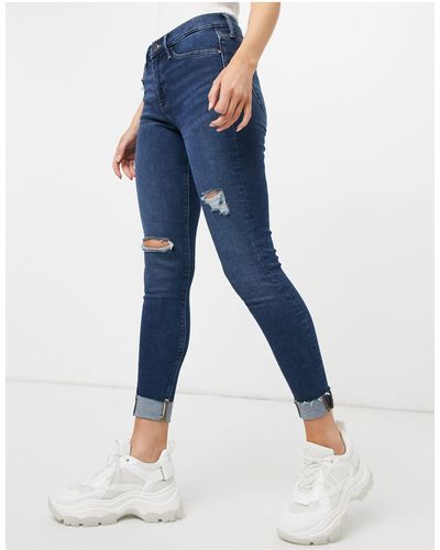 River Island Molly - jeans skinny scuro autentico con fondo grezzo e strappi - Blu