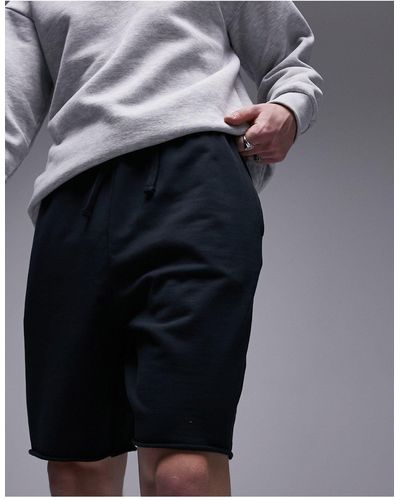 TOPMAN Pantalones cortos extragrandes con lavado y bajos sin rematar - Negro