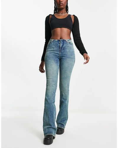 Reclaimed (vintage) Jean skinny stretch évasé sans bande à la taille - délavé moyen - Bleu