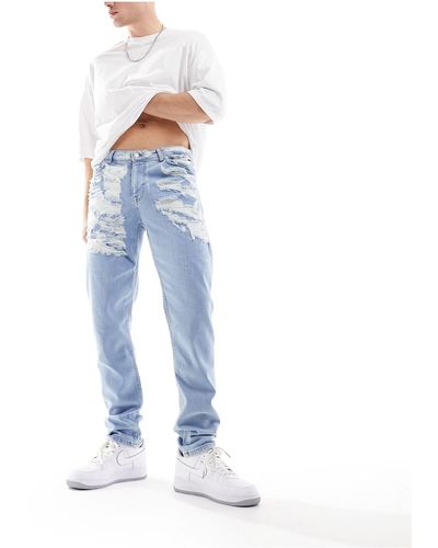 ASOS Jeans skinny lavaggio chiaro con strappi vistosi - Blu