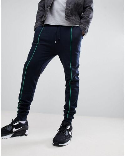 ASOS Skinny sweatpants In Navy With Light Green Piping - Blue