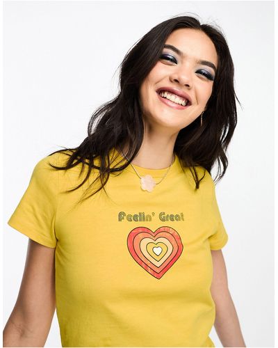 ASOS T-shirt raccourci avec motif feeling great style années 70 - Jaune