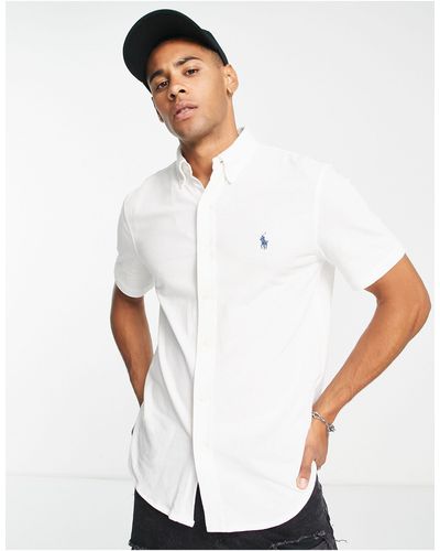Polo Ralph Lauren – kurzärmliges, schmal geschnittenes pikee-t-shirt mit polospieler-logo - Weiß