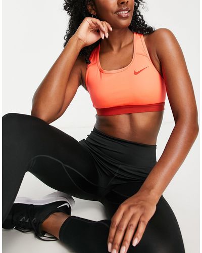 Nike Dri-fit swoosh - reggiseno sportivo a supporto medio scuro con logo - Rosa