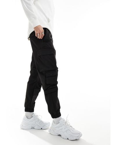 Bershka Pantalon cargo technique à poches - Noir