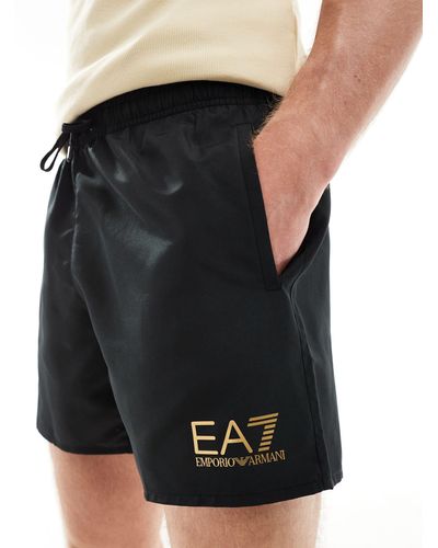 EA7 Armani - pantaloncini da bagno neri con logo dorato - Nero
