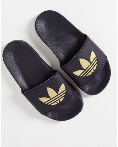 adidas Originals Adilette lite - sliders nere con trifoglio color oro - Blu