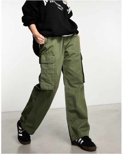 New Look Pantaloni cargo slim con doppia tasca color kaki - Verde