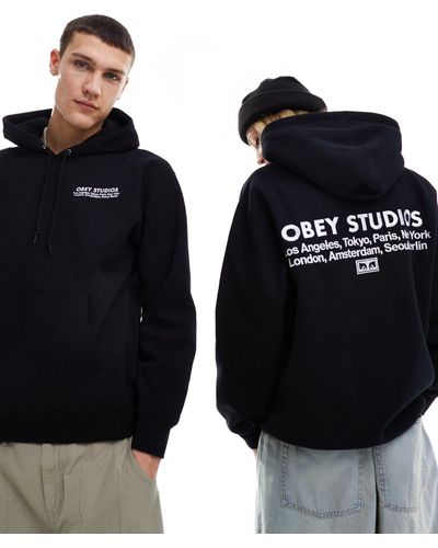 Obey Studios - felpa nera unisex con stampa sulla schiena e cappuccio - Nero