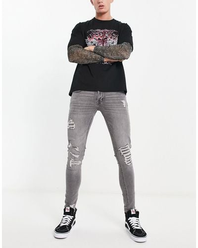 ADPT Jeans skinny effetto spray slavato con strappi vistosi - Nero