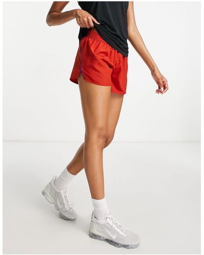 Nike Icon clash 10k - pantaloncini scuro - Arancione