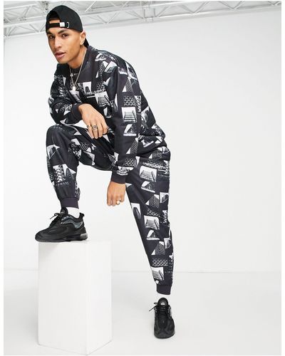ASOS Asos Unrvlld Spply Tracksuit With All Over Photographic Design & Logo Print - Black