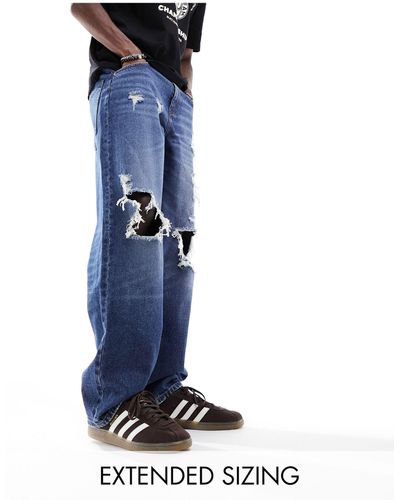 ASOS Jeans ampi lavaggio medio con strappi vistosi - Blu