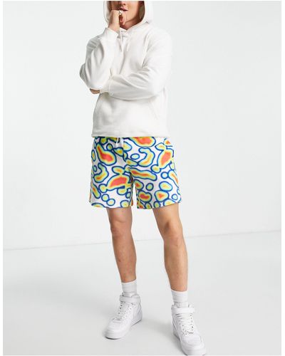 ASOS Pantalones cortos holgados con estampado gráfico integral - Multicolor