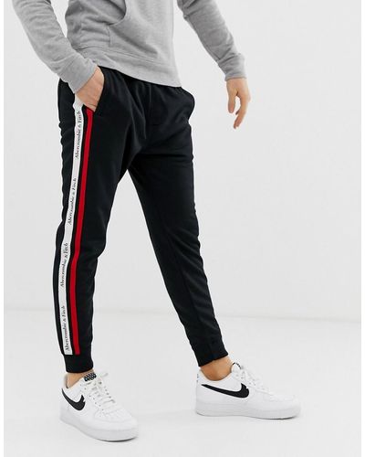 Abercrombie & Fitch Pantalon de jogging resserr aux chevilles en tricot avec bande logo sur le ct - Noir