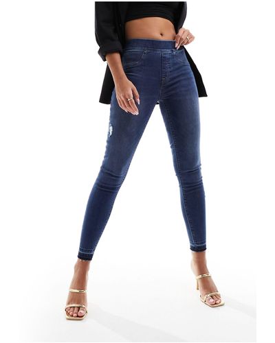 Spanx Jeans skinny modellanti e con effetto sollevante lavaggio medio invecchiato - Blu