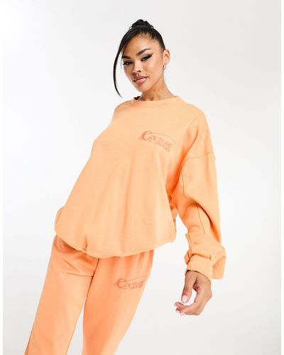 The Couture Club Sweat d'ensemble oversize imprimé dans le dos - Orange