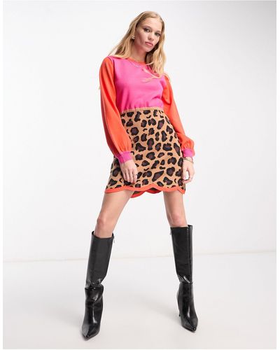 Never Fully Dressed Vestito corto con stampa leopardata e maniche lunghe a contrasto - Rosso