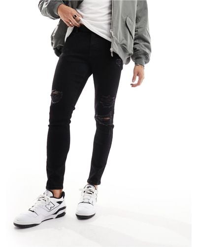 ASOS Spray On Jeans With Power Stretch And Heavy Rips - Black