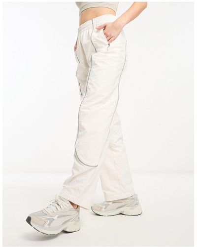 The North Face Tek - pantaloni sportivi color crema con profili riflettenti - Bianco