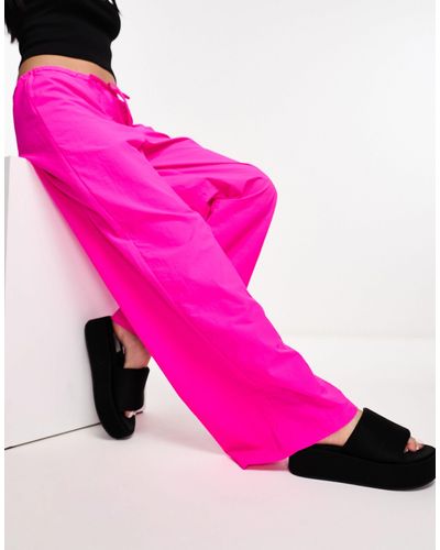 Collusion Pantaloni parachute a vita bassa con fondo ampio rosa acceso