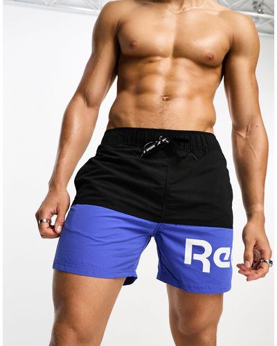 Reebok Deakin - pantaloncini da bagno color block e neri - Blu