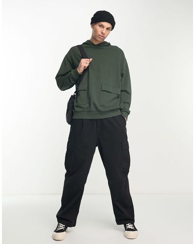 ASOS Sudadera verde extragrande con capucha, bolsillo cargo y detalles ajustables