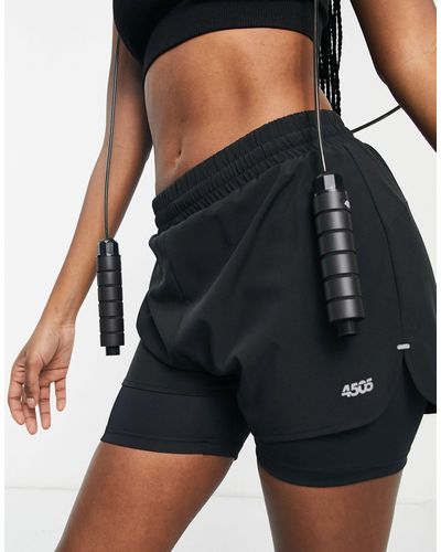 ASOS 4505 Pantalones cortos deportivos con capa inferior y logo - Negro