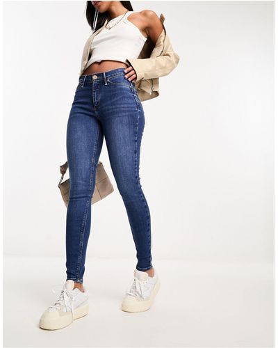 River Island Molly - jeans skinny a vita medio alta modellanti lavaggio medio - Blu