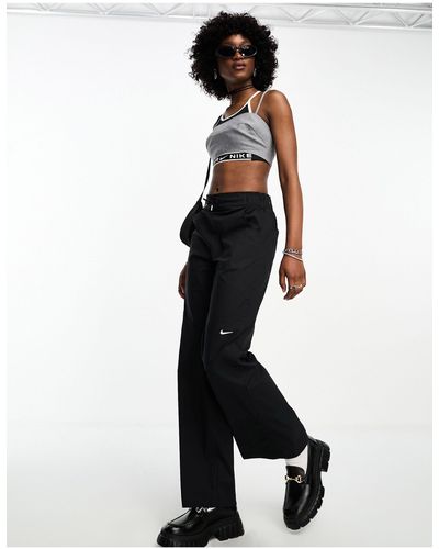 Nike Pantalon tissé à taille haute et petit logo virgule - Blanc