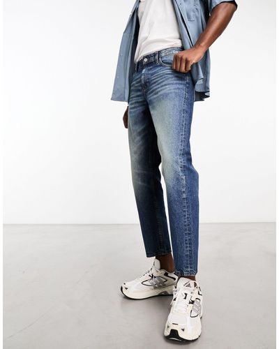 ASOS Jeans stile skater lavaggio scuro con sfumature - Blu
