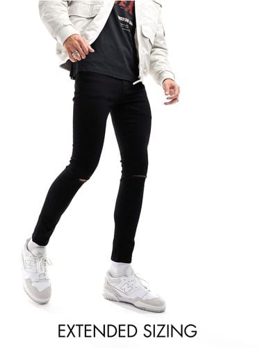 ASOS Jeans super skinny ed elasticizzati neri con strappi sulle ginocchia - Nero