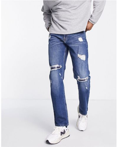 Hollister Jean droit slim effet vieilli et réparé avec empiècements en flanelle - délavage foncé - Bleu