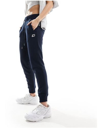 New Balance Pantaloni neri con logo nb piccolo - Blu